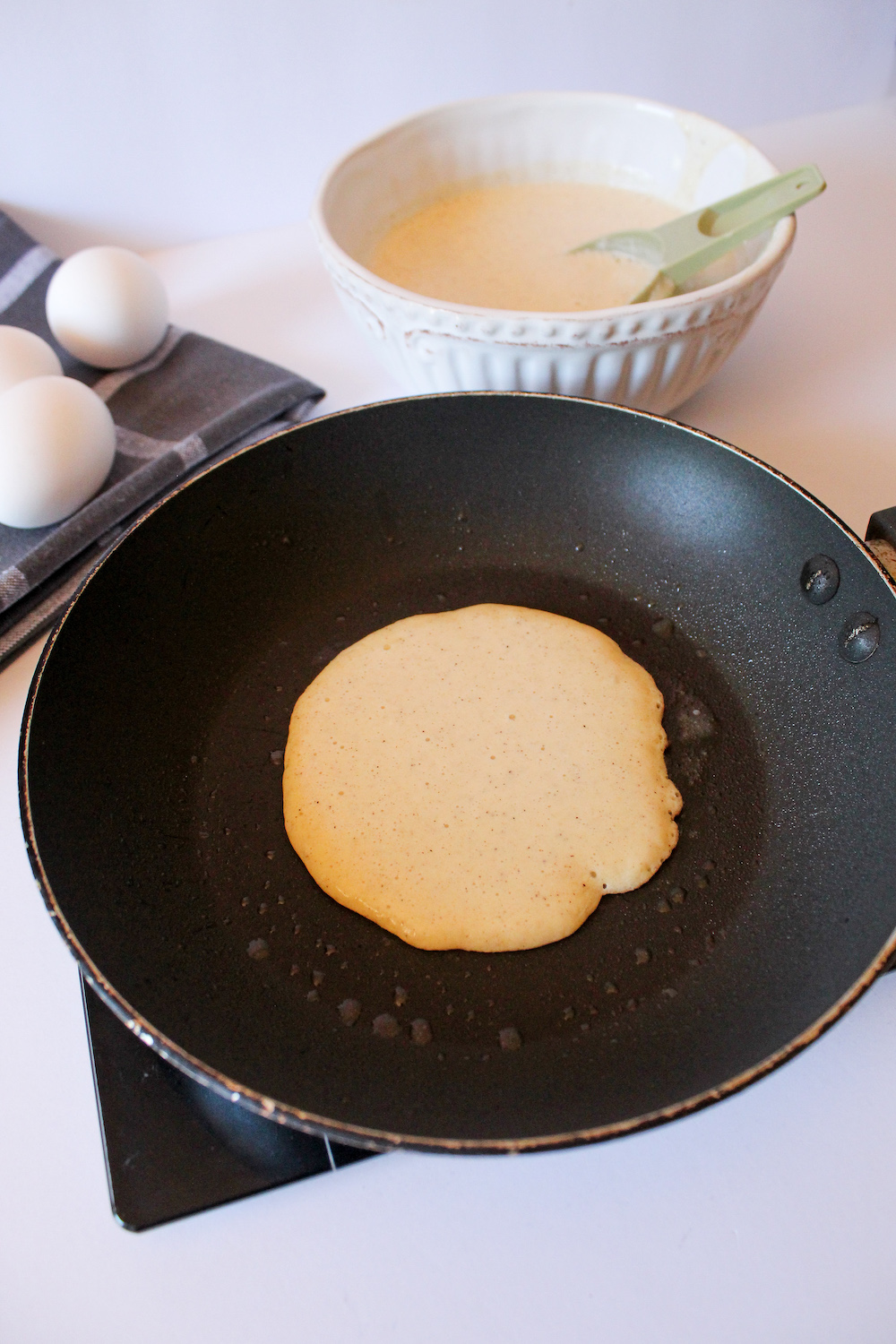 Keto Almond Flour Pancakes cooking over medium heat