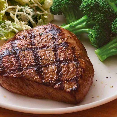 Image showcasing a protein-rich 6 oz. Top Sirloin steak accompanied by vibrant, steamed broccoli and a fresh salad, representing a healthy, low-carb meal option.